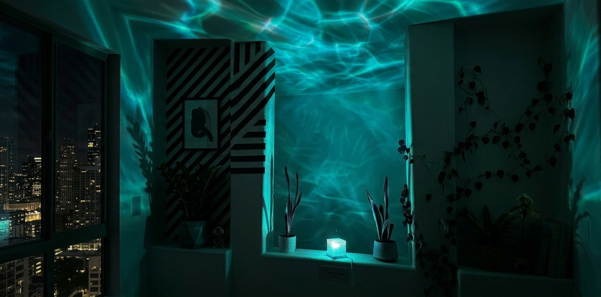 Ocean wave light rippling across a bedroom wall and ceiling at night
